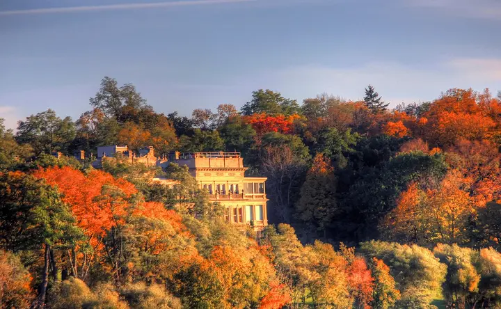 Lakeside mansion surrounded by autumn trees near Geneva Lake