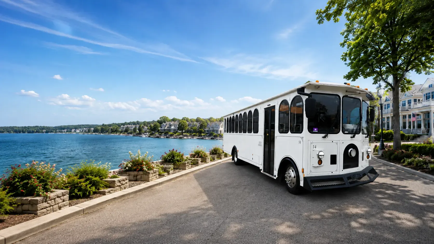 White trolley beside a lakefront promenade